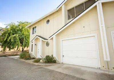 a house with two garage doors on the side of it at Comfort meets Tranquility by the Sequoia Entrance in Three Rivers