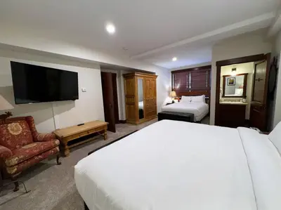 a hotel room with a large bed and a television at Luxury Townhome w/ Views, Private Jacuzzi & Garage in Mammoth Lakes
