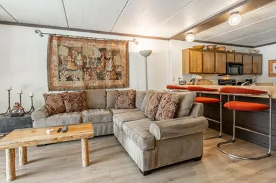 a living room with a couch and a table at Updated 2 Bedroom 2 Bathrooms 1849 Condos #109 Steps to Canyon Lodge Sleeps 6 in Mammoth Lakes