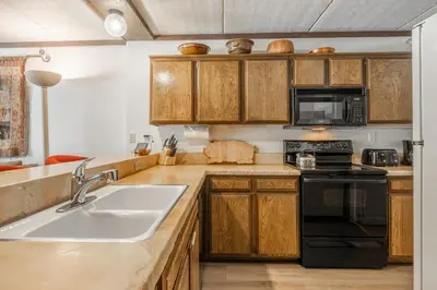 a kitchen with a sink and a microwave at Updated 2 Bedroom 2 Bathrooms 1849 Condos #109 Steps to Canyon Lodge Sleeps 6 in Mammoth Lakes