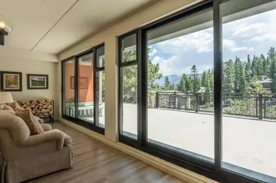 a living room with large sliding glass doors at Updated 2 Bedroom 2 Bathrooms 1849 Condos #109 Steps to Canyon Lodge Sleeps 6 in Mammoth Lakes