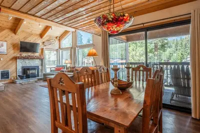 a dining room and living room with a table and chairs at Courchevel #15 - 2 Bedroom, 2 Bathroom, Sleeps 6! Just steps to Canyon Lodge! in Mammoth Lakes