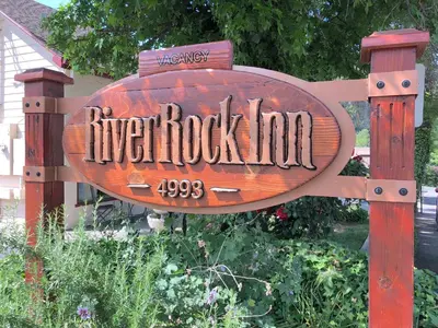 a wooden sign that reads river rock tool at River Rock Inn in Mariposa