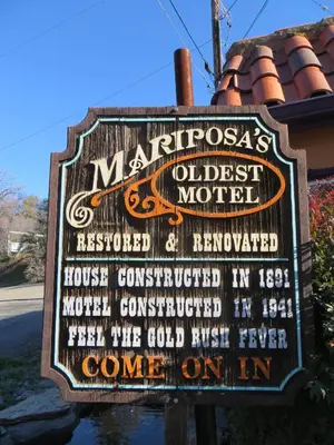 a sign for the oldest motel at River Rock Inn in Mariposa