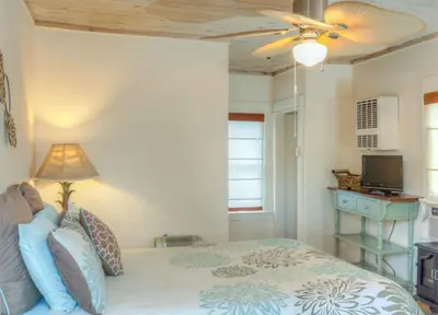 a bedroom with a bed and a ceiling fan at River Rock Inn in Mariposa