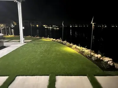 a grassy pathway with a view of the water at night at Waterfront Resort Style Villa - 5 min to fastwater in Oakley