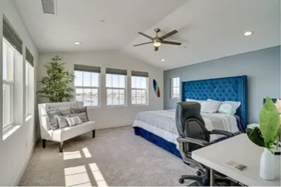 a bedroom with a bed and a desk and chairs at Waterfront Resort Style Villa - 5 min to fastwater in Oakley