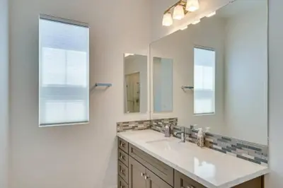 a bathroom with a sink and two mirrors at Waterfront Resort Style Villa - 5 min to fastwater in Oakley
