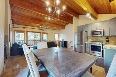 a kitchen and dining room with a wooden table at Wild Horse Hideaway in Incline Village