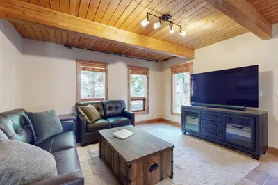 a living room with a couch and a flat screen tv at Wild Horse Hideaway in Incline Village