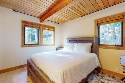 a bedroom with a large white bed with two windows at Wild Horse Hideaway in Incline Village