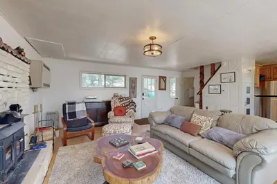 a living room with a couch and a table at 10 Mi to Bear Valley Resort Serene Mtn Retreat in Tamarack
