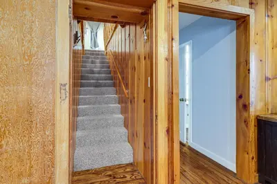 a stairway in a log cabin with a mirror at California Mountain Cabin with Lake Access and Deck! in Long Barn