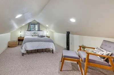 a bedroom with a bed and two chairs in it at California Mountain Cabin with Lake Access and Deck! in Long Barn