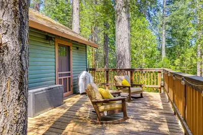 a wooden deck with chairs and a house at California Mountain Cabin with Lake Access and Deck! in Long Barn