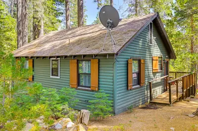 a blue tiny house in the woods at California Mountain Cabin with Lake Access and Deck! in Long Barn