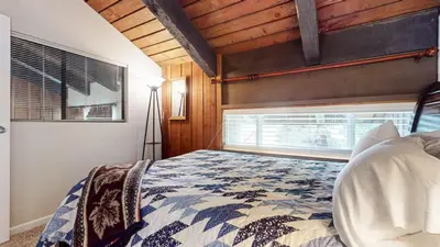 a bedroom with a bed and a window at Mammoth Ski & Racquet Club #118 condo in Mammoth Lakes