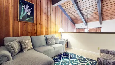 a living room with a couch and a chair at Mammoth Ski & Racquet Club #118 condo in Mammoth Lakes