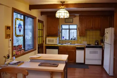 a kitchen with wooden cabinets and a white refrigerator at HighlandHouse in Arnold