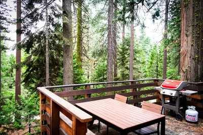 a wooden deck with a grill and a picnic table at HighlandHouse in Arnold