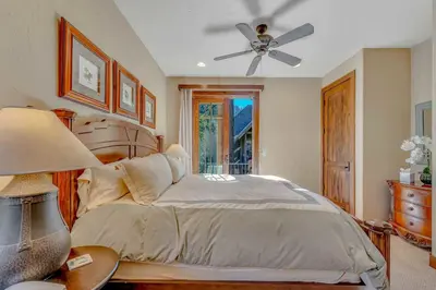 a bedroom with a bed and a ceiling fan at Lakefront Retreat Across from Homewood Resort in Homewood