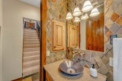 a bathroom with a sink and a mirror at Lakefront Retreat Across from Homewood Resort in Homewood