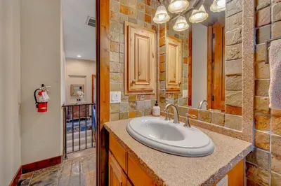 a bathroom with a sink and a mirror at Lakefront Retreat Across from Homewood Resort in Homewood