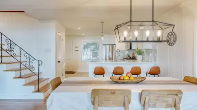a dining room and kitchen with a table and chairs at West Shore Lake House by AvantStay Ski Cabin w Backyard Sledding Hill in Homewood