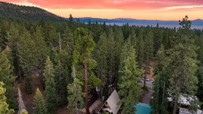 an aerial view of a forest with a house and a road at Speckled by AvantStay Modern Interior 0.5mi to Lake in Kings Beach