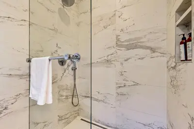 a bathroom with a shower with a glass door at Modern Mountain Getaway in Olympic Valley
