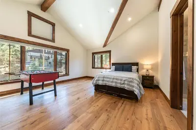 a bedroom with a bed and a ping pong table at Arcadia Manor on the West Shore - Newly Built - 5 BR w Wet Bar EV Charger and Air Conditioning in Tahoe City