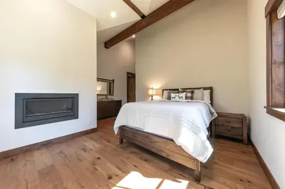 a bedroom with a bed and a fireplace at Arcadia Manor on the West Shore - Newly Built - 5 BR w Wet Bar EV Charger and Air Conditioning in Tahoe City