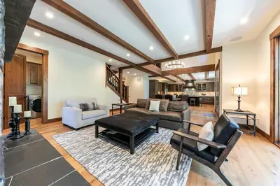 a living room with a couch and a table at Arcadia Manor on the West Shore - Newly Built - 5 BR w Wet Bar EV Charger and Air Conditioning in Tahoe City