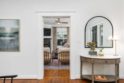 a living room with a mirror and a table at Luxe Retreat Designed For Group Getaways in Lodi