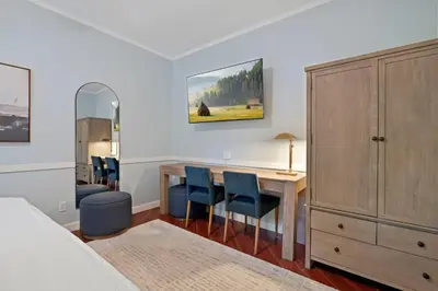 a bedroom with a desk and chairs and a bed at Luxe Retreat Designed For Group Getaways in Lodi