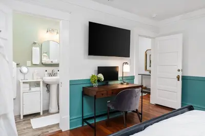 a bedroom with a desk and a sink and a bed at Luxe Retreat Designed For Group Getaways in Lodi