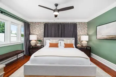 a bedroom with a large bed with a ceiling fan at Luxe Retreat Designed For Group Getaways in Lodi