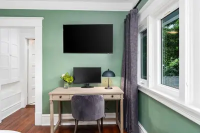 a desk with a monitor and a chair in a room at Luxe Retreat Designed For Group Getaways in Lodi
