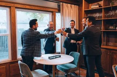 a group of men shaking hands in a room at Luxe Retreat Designed For Group Getaways in Lodi