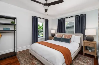a bedroom with a large white bed and windows at Luxe Retreat Designed For Group Getaways in Lodi