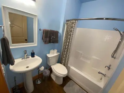 a bathroom with a toilet and a sink and a shower at The Hilltop Cabin Retreat in Bass Lake Heights in Oakhurst