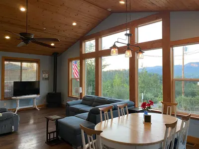 a living room with a table and a couch at The Hilltop Cabin Retreat in Bass Lake Heights in Oakhurst