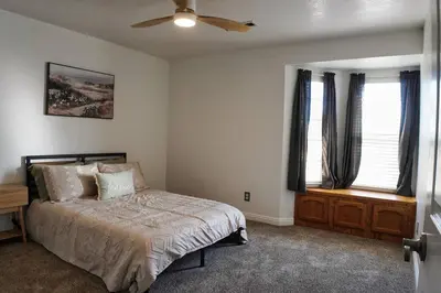 a bedroom with a bed and a ceiling fan at Fernwood Retreat at Madera Ranchos in Madera