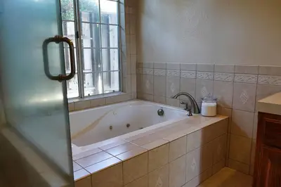 a bath tub in a bathroom with a window at Fernwood Retreat at Madera Ranchos in Madera