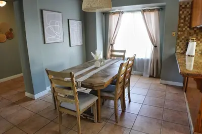 a dining room with a wooden table and chairs at Fernwood Retreat at Madera Ranchos in Madera