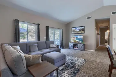 a living room with a couch and a tv at Yosemite Hilltop Gated Villa near Oakhurst, Bass Lake and Mariposa w EVCharger Hottub Grill and Awesome Views! in Ahwahnee