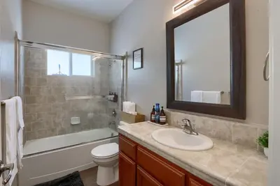 a bathroom with a sink and a toilet and a mirror at Yosemite Hilltop Gated Villa near Oakhurst, Bass Lake and Mariposa w EVCharger Hottub Grill and Awesome Views! in Ahwahnee