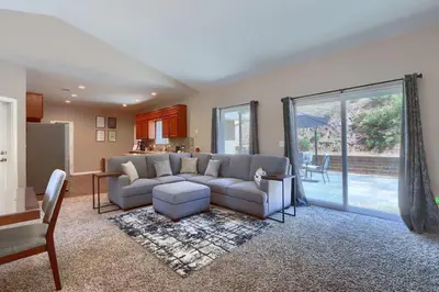 a living room with a couch and a table at Yosemite Hilltop Gated Villa near Oakhurst, Bass Lake and Mariposa w EVCharger Hottub Grill and Awesome Views! in Ahwahnee