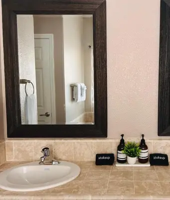 a bathroom with a sink with a mirror and plants at Yosemite Hilltop Gated Villa near Oakhurst, Bass Lake and Mariposa w EVCharger Hottub Grill and Awesome Views! in Ahwahnee