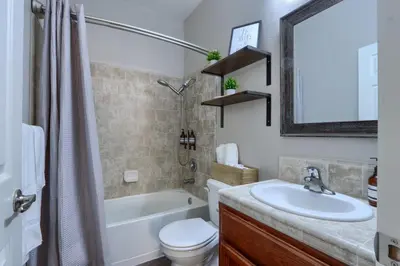 a bathroom with a sink and a tub and a toilet at Yosemite Hilltop Gated Villa near Oakhurst, Bass Lake and Mariposa w EVCharger Hottub Grill and Awesome Views! in Ahwahnee
